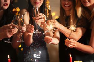 Luciana Scrofani Green Italian English interpreter Happy women with Christmas sparklers and glasses of champagne at party