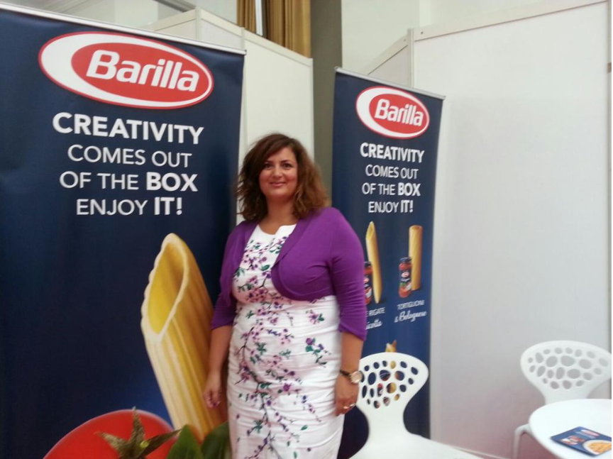 Luciana in front of Barilla Pasta Banner